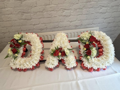 Massed Letters - A heartfelt and personalised funeral tribute created to honour the memory of a loved one. Designed in a timeless combination of white and red tones, this elegant letter arrangement expresses love, gratitude, and remembrance, serving as a touching final farewell.

Each letter is carefully handcrafted with fresh seasonal blooms and finished with coordinating ribbon edging, creating a meaningful and dignified display.